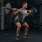Mesomorph athlete lifting weights in a gym, showcasing strength and focus