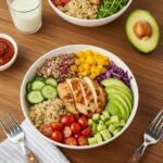 Colorful clean eating meal with grilled chicken, quinoa, and fresh vegetables