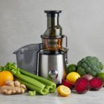 Fresh fruits and vegetables being juiced for weight loss, highlighting ingredients like celery, beets, and ginger
