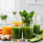 Freshly made detox juices with fruits and vegetables in a bright kitchen setting