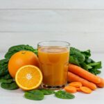 Freshly squeezed vitamin juice with fruits and vegetables highlighting health benefits
