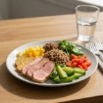 Healthy meal plate with lean proteins, vegetables, and whole grains representing mesomorph diet principles