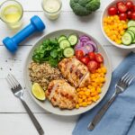 Healthy post-workout meal with grilled chicken, quinoa, and fresh vegetables in a bright kitchen