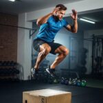 Mesomorph athlete performing explosive plyometric jumps in a gym, highlighting strength and agility
